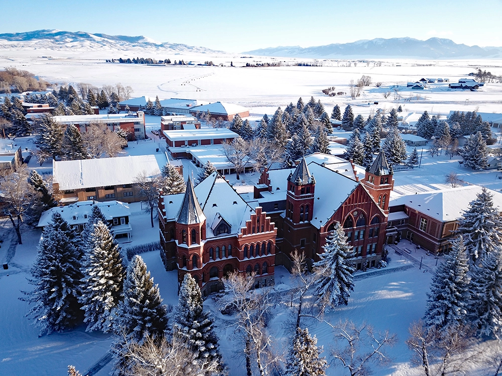 Aerial view of Montana Westerns snow-covered campus and Main Hall.