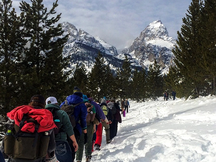 Students examine archival items in a box during class.
