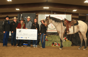 2025 UMW Colt Challenge winner Kat Hansen and colt RSR BET UR GUNS receiving winning check.