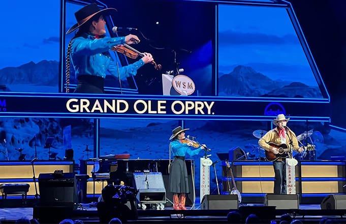 UMW student Brigid Reedy performs at the Grand Ole Opry with artist Andy Hedges